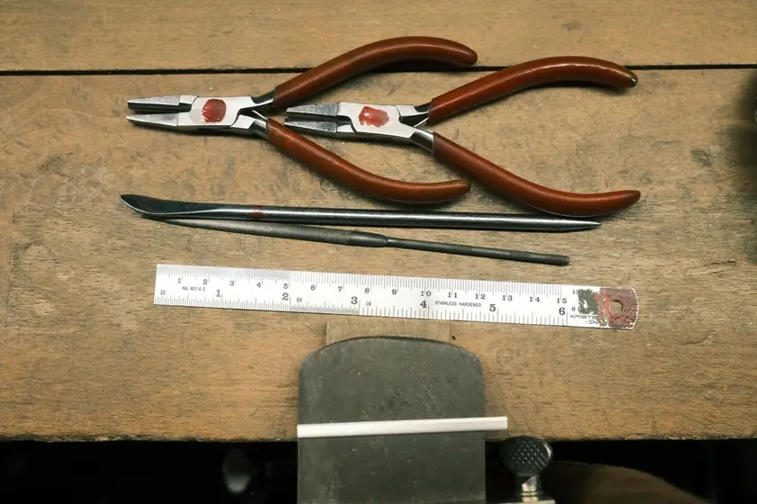 Real photograph of practical hand tools on a wooden workbench
